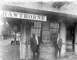 Two men standing in front of the Hawthorne train station
