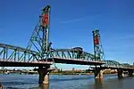 Green metal bridge with lift rising