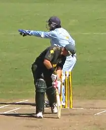 Here the batsman has played a shot and missed, with the wicketkeeper receiving the ball. The 'keeper, believing that in playing his shot the batsman has ventured beyond his popping crease, has broken the stumps with the ball in an attempt to dismiss him 'stumped'. He is appealing to the umpire to review and either accept or refuse the dismissal. It now falls to the umpire to adjudge whether the batsman had indeed ventured beyond his crease, a decision that in modern cricket is assisted by technology and replays.