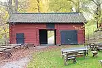 Hewn log barn painted red in Hedemora, Sweden.