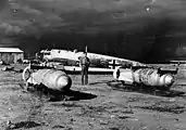 Two SC 1000 bombs with "kopfrings", stored on sledges in front of a wrecked German Heinkel He 111H bomber at Benghazi airfield Libya in early 1943.