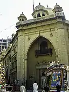 The front of the building has a large Islamic style arch