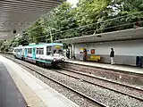 An Altrincham-bound T-68 tram arriving at Heaton Park.