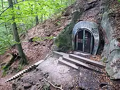 Railway tunnel exit opening out in rough terrain