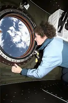 Astronaut Susan Helms looks out the nadir window, 2001