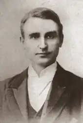 Head and shoulders photograph of young, clean-shaven white man in neat morning wear