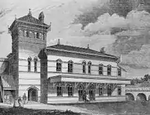 Black and white line drawing of a two-storey gothic revival building having a square tower to its left and a railway viaduct to the right.