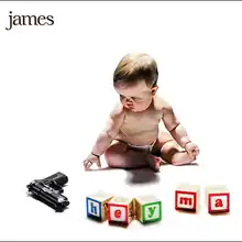 A baby sat behind a gun and some building blocks against a white background