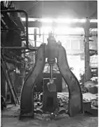 Small steam hammer 1900, with line shafting and belt drives to the rear.