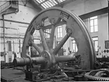 Rolling mill flywheel. The wheel is rotated by the pinion on the right.