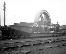 Flatcar loaded with a flywheel 1900.
