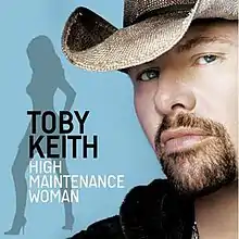 The light blue cover features a man with a goatee and cowboy hat, and a woman's silhouette. Both the artist's name and song title are superimposed on the silhouette, colored in black and white respectively.