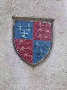 The school's arms on a monument in the town