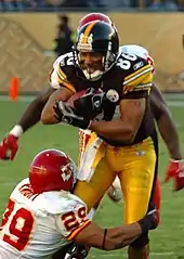 Hines Ward attempts to break an opponent's tackle