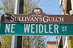 Sullivan's Gulch street sign topper on NE Weidler St