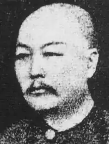 A head-and-sholders, photographic portrait of a middle-aged, Asian man
