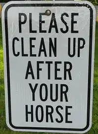Sign in the township office parking lot on the hitching rail for Amish buggies
