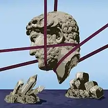 The head of a statue facing left, supported by purple cables in mid-air, is set against a pale blue sky and is the centre of the picture. Below it in the dark blue foreground are crystalline rocks, which point towards the head.