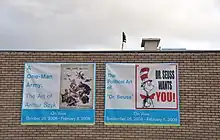Advertisement in front of Houston Holocaust Museum announcing display of cartoons by Arthur Szyk and Dr. Seuss during World War II (pre-renovation building)