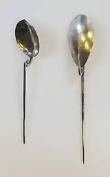 two longhandled spoons, the "handle" is a tapering metal spike