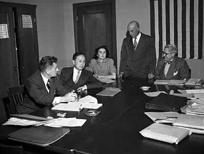 Xuesen at his deportation hearing, 1950. Others, from left, are Grant B. Cooper, Xuesen's attorney; a hearing reporter, Albert Del Guercio, examining officer, and Ray Waddell, hearing officer.