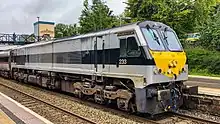 A black/grey liveried Class 201 locomotive stopped at Lisburn train station