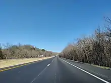 Driver's view of a straight, flat, four-lane divided highway