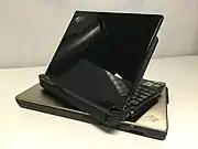 The ThinkPad S31 with the piano black finish option sitting on top of a Z61t; both ThinkPads deviate from the usual matte black.