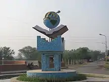 Photograph of the sculpture of logo at the entrance of the institute