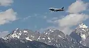 An American A319 approaching the airport with the Teton range in view