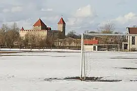 The stadium with the historic Kuressaare Castle in the background