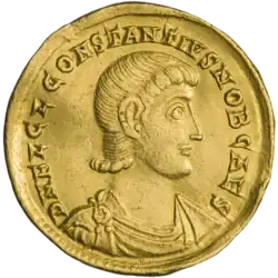 Golden coin depicting man facing right