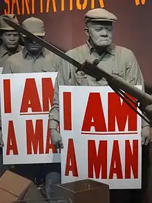 A diorama of the Memphis sanitation strike showing posters reading "I AM A MAN"