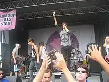 I See Stars performing at the Vans Warped Tour in 2010. From left to right: Jimmy Gregerson (former), Jeff Valentine, Andrew Oliver (behind), Brent Allen.