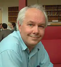 White-haired man in blue shirt