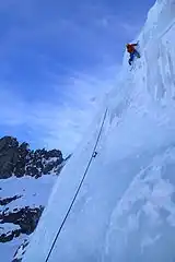 Ice climbing with ice axes and crampons.