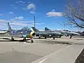 A static display of a North American F-86A Sabre (replica), a MiG-21 (originally Polish, but in Soviet livery here), and a McDonnell-Douglas RF-4C Phantom.