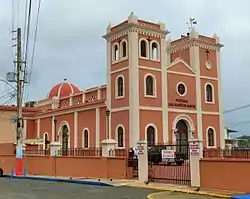 Photograph of a church with a symmetrical facade with two towers and a low central dome