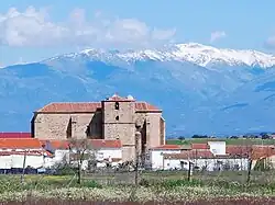 Church of St John the Baptist, Saucedilla  with the Sierra de Gredos snow-covered behind