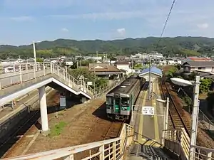 A view of the eastern (Naruto Line) platforms looking in the direction of Naruto. The station building is in the centre and the Kōtoku Line platforms can be glimpsed to the extreme left.