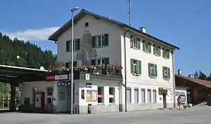 Three-story stone building with gabled roof