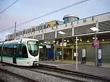 Tram stop with entrance the RER station behind