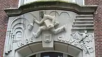 Facade relief In de Cluys, 1942, Nel Klaassen, Markt Middelburg, above bank.