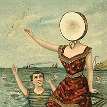 A drawing of a young boy and a woman out at sea. The boy is swimming, while the woman sits atop a dock. She is wearing a red dress and has a drumhead for a face. A steam-powered ship can be seen in the background.