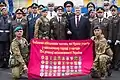 President Poroshenko and the commanders of  all parade contingents in front of a banner depicting the logos of all military units in the parade.