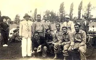 India cyclists at the 1948 Olympics (standing, l to r: Bhoot (in jacket with hat), Adi Havewala, x, Nariman Saugar (in jacket with cap); seated, l to r: x (in blazer), x, Malcolm, Mehra, x)