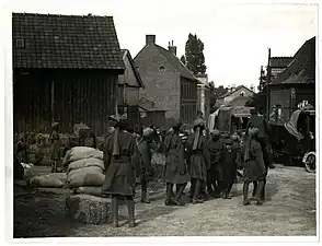 Indian Cavalry Regiment unloading supplies of hay & oats from supply column motor lorry (Estrée Blanche, France)