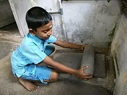 Use of a metate in India