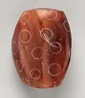 Indus Civilisation Carnelian bead with white design, ca. 2900–2350 BCE. Found in Nippur, Mesopotamian.