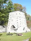 An antique stone furnace tower